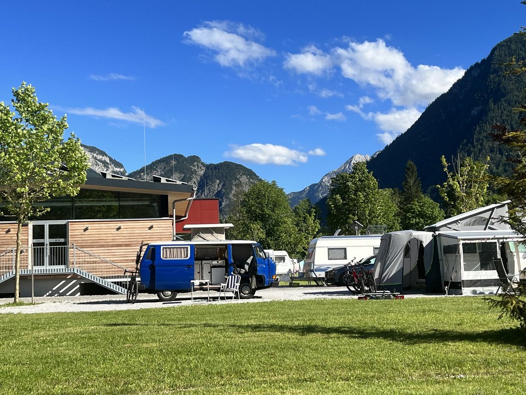 Mehrere Camper geparkt neben Hütte in den Bergen